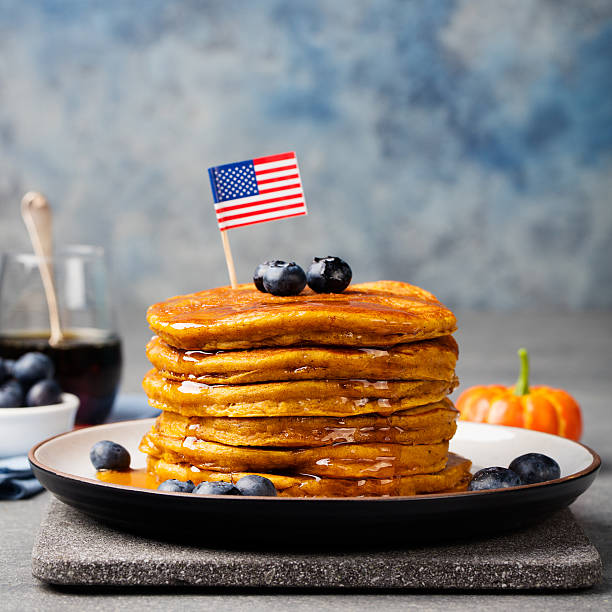 istock Pumpkin pancakes with maple syrup, blueberries American flag on top 544984934