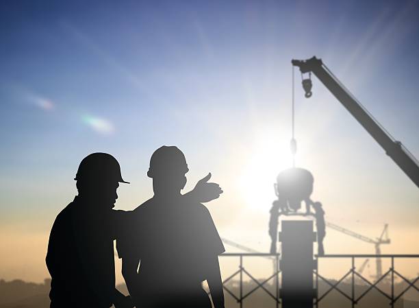 istock silhouette man survey and civil engineer stand on ground working 544988592