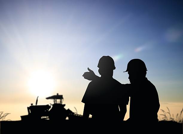 istock silhouette man survey and civil engineer stand on ground working 544988640