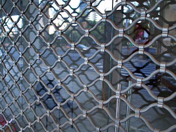 Shop window protected by iron bars security shutter stock photo