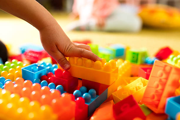 istock Hand of a child building something with toy blocks. 544990896
