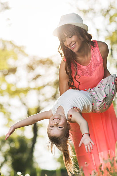 istock Playful mother having fun with her small daughter in nature. 544991784
