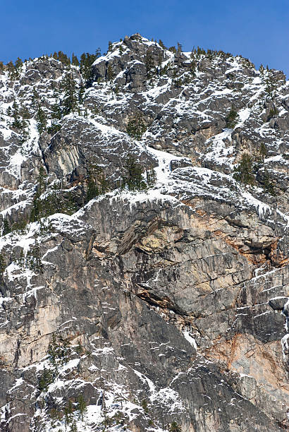 istock Tall Rock Face with Winter Snow and Icicles 544991902