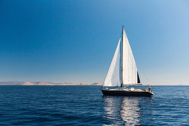 istock Sailing ship luxury yacht with white sails in the Sea. 544992098