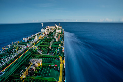 Ship at sea showing motion with blurred water.  