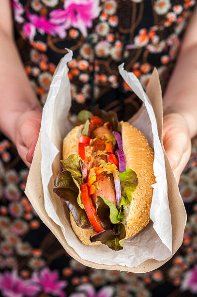 istock Delicious hotdog in female hands 544993638