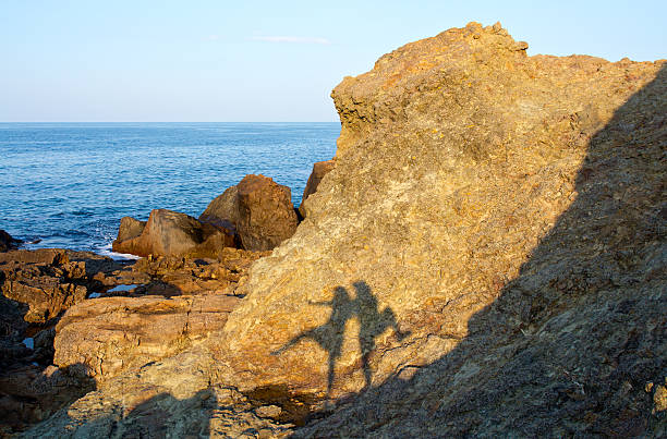 istock Couple silhouette reflecting on rock 544993724