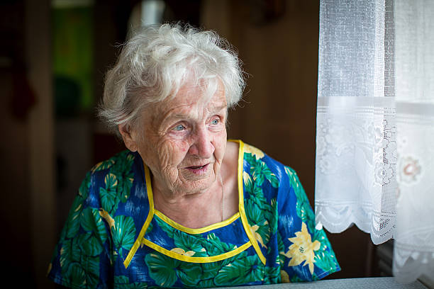 istock Granny is sitting near the window in the kitchen. 544994796