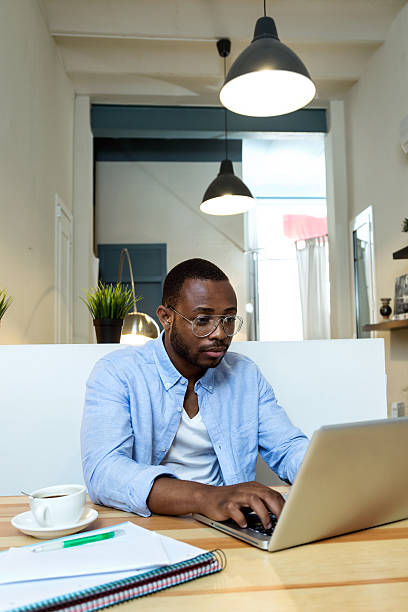 istock Handsome young black man working with laptop at home. 544995104