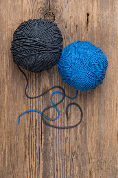 istock Two balls of knitting yarn on wooden surface 544995934