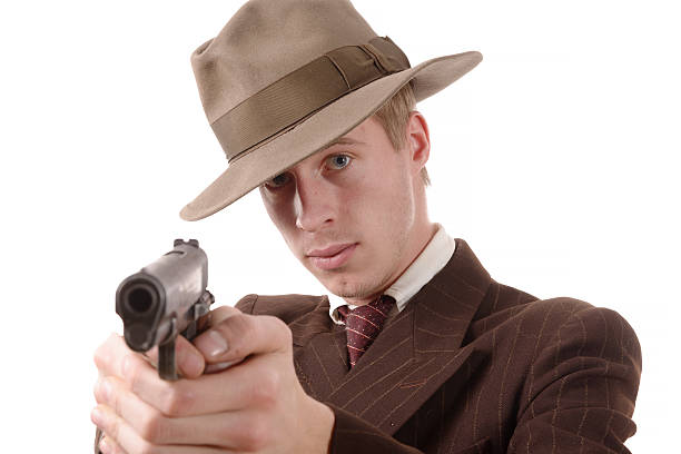 istock gangster in a suit vintage, aim with a gun 544996678