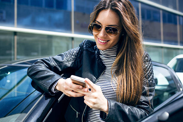 istock Beautiful young woman using her mobile phone in the car. 545081986