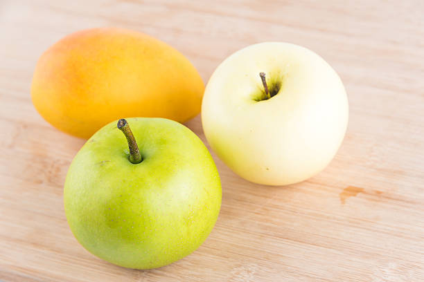 istock Pear,apple and mango on wooden background 545082150
