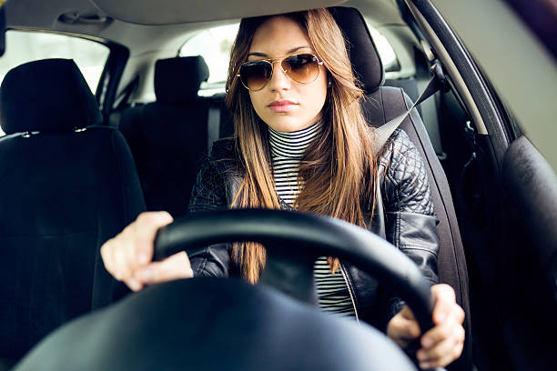 istock Beautiful young woman driving her car. 545082610