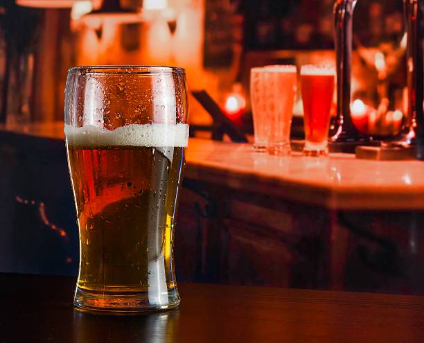 glass of fresh beer on wood table