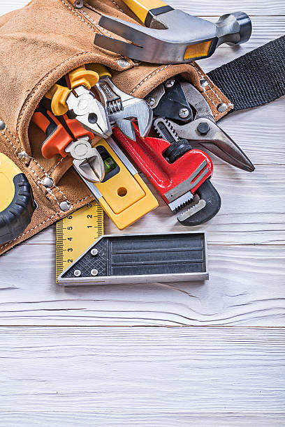 istock Leather building belt with construction equipment on wooden boar 545084588