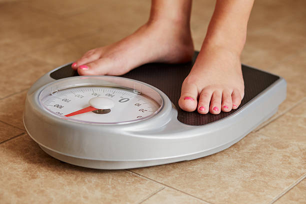 istock Female feet on a bathroom scale 545085570