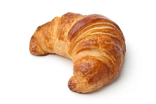 Single fresh baked croissant on white background