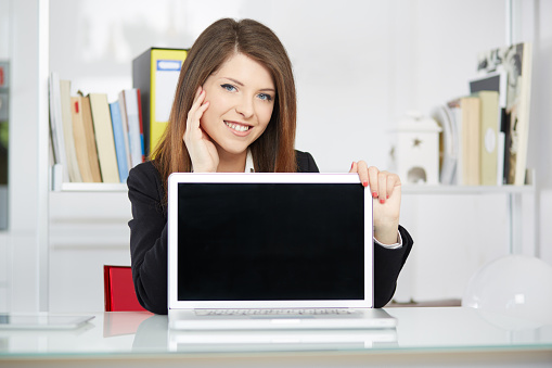 young businesswoman showing blank screen