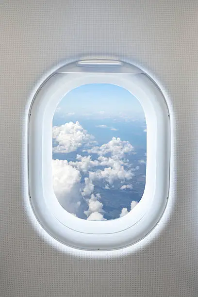 Close up aircraft window interior view with beautiful cloudy from outside concept background.