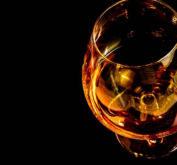 istock snifter of brandy in elegant typical cognac glass on black 545089990