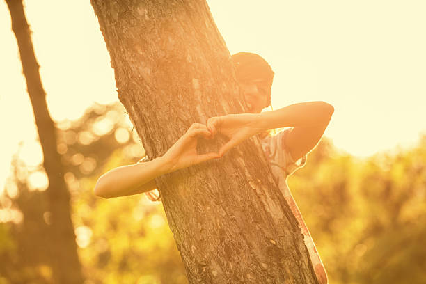 Girl sharing her heart with the tree.