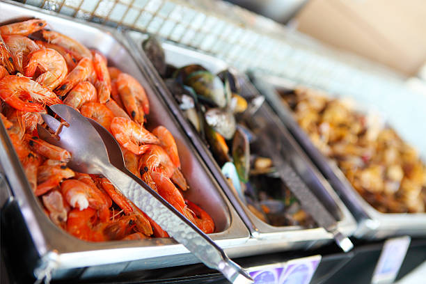 Buffet table with seafood with shrimps, fried calamari rings and  mussels. Close up