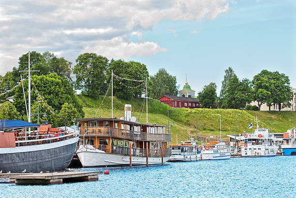 Lappeenranta, Finland. People in the floating restaurant Lappeenranta, Finland - June 15, 2016: People sit in the floating restaurant on The  Saimaa Lake embankment. On the background is Harbor Market and Linnoitus Fortress last territory. lappeenranta stock pictures, royalty-free photos & images