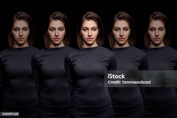 Group Of Young Pretty Women Clones Standing In A Row Stock Photo - Download Image Now