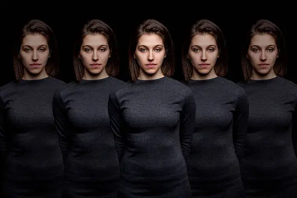 Group of young pretty women clones standing in a row