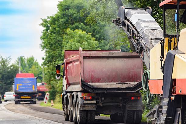 istock Asphalt removing machine loading powdered asphalt on the truck 545092168