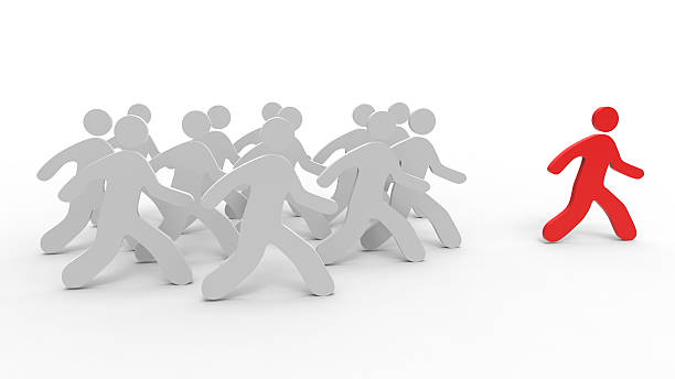 istock Stick figures of grey people following a leader 545092500
