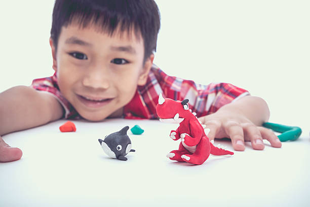 istock Funny asian child playing with clay, on white background. 545093296