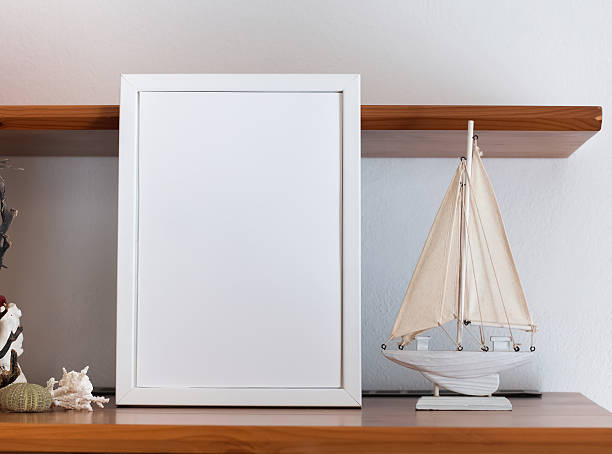 istock Mock up with blank frame and little boat 545096300