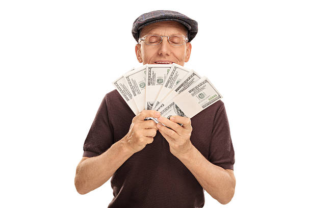 istock Senior holding and smelling money 545097606