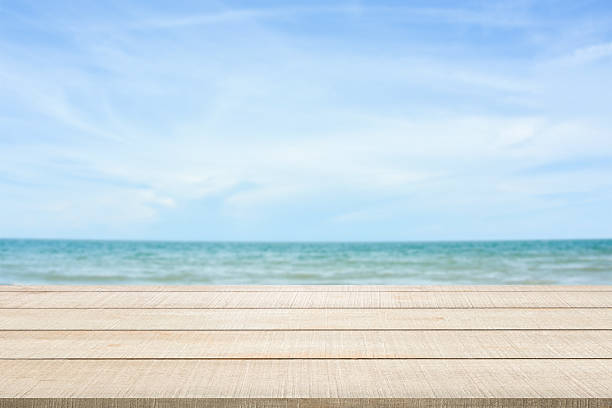 istock wood table top on blurred seascape 545098196