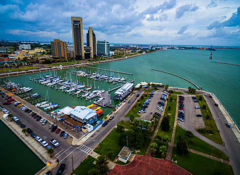 Paradise Gulf of Mexico Corpus Christi Texas Marina Aerial. The T-head with the marina , boats , sailboats , yachts , Tall Twin Towers at downtown Corpus Christi. Calm waters on the pier and inside the marina or harbor. The USS lexington is in the distance also called the \
