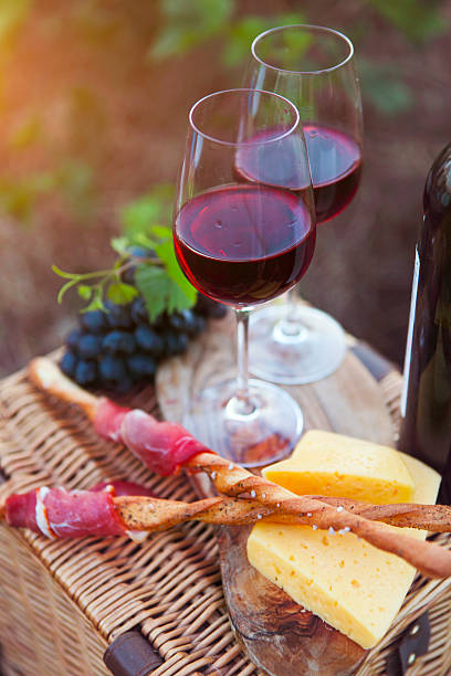 istock Two glasses of red wine with bread, meat, grape, cheese 545101066
