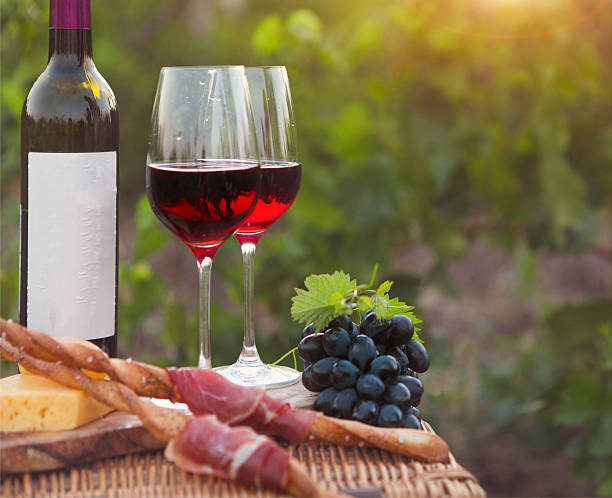 istock Two glasses of red wine with bread, meat, grape, cheese 545101136