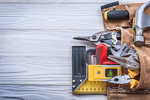 istock Leather toolbelt with building implements on wooden board copy s 545101518