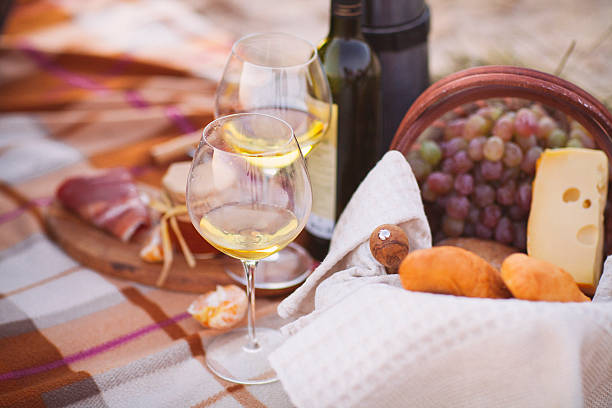Autumn picnic by the sea with wine, grapes, bread, cheese Autumn picnic by the sea with wine, grapes, bread,  jam and cheese montreux stock pictures, royalty-free photos & images