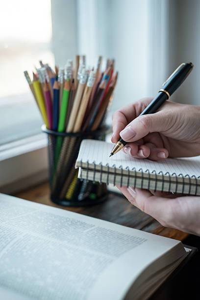 istock Young woman writing memos in front of big window 545102504