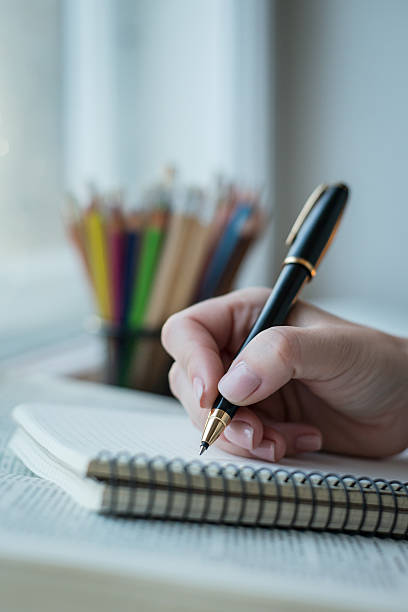 istock Young woman writing memos in front of big window 545102686