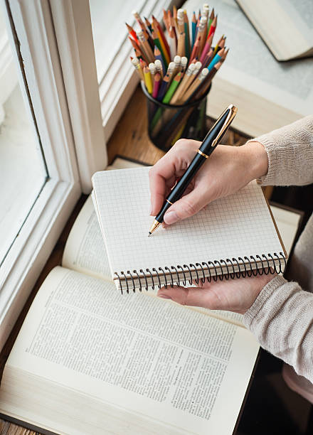 istock Young woman writing memos in front of big window 545102882