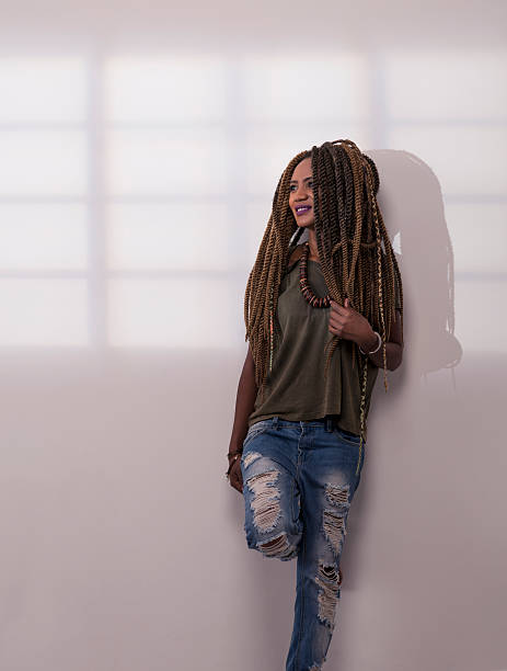 istock African woman with dreadlocks looking though window. 545104166
