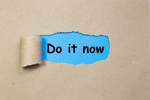 istock The word Do it Now appearing behind torn paper 545105382