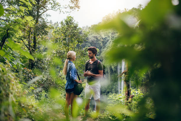 istock Couple of hikers together in forest 545111008