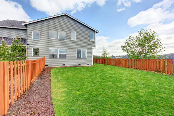 istock Spacious fenced back yard with green grass. 545111346