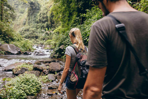 istock Tourist couple walking by stream 545111992
