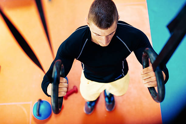 istock Overhead image of athlede doing chin ups on gymnastic rings 545112808